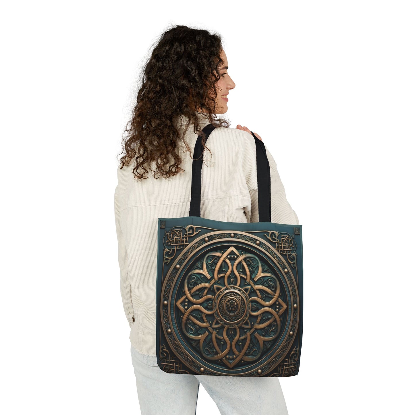 Woman wearing a beige jacket carrying Celtic Shield Knot Turquoise and Bronze Tote Bag with black handles.