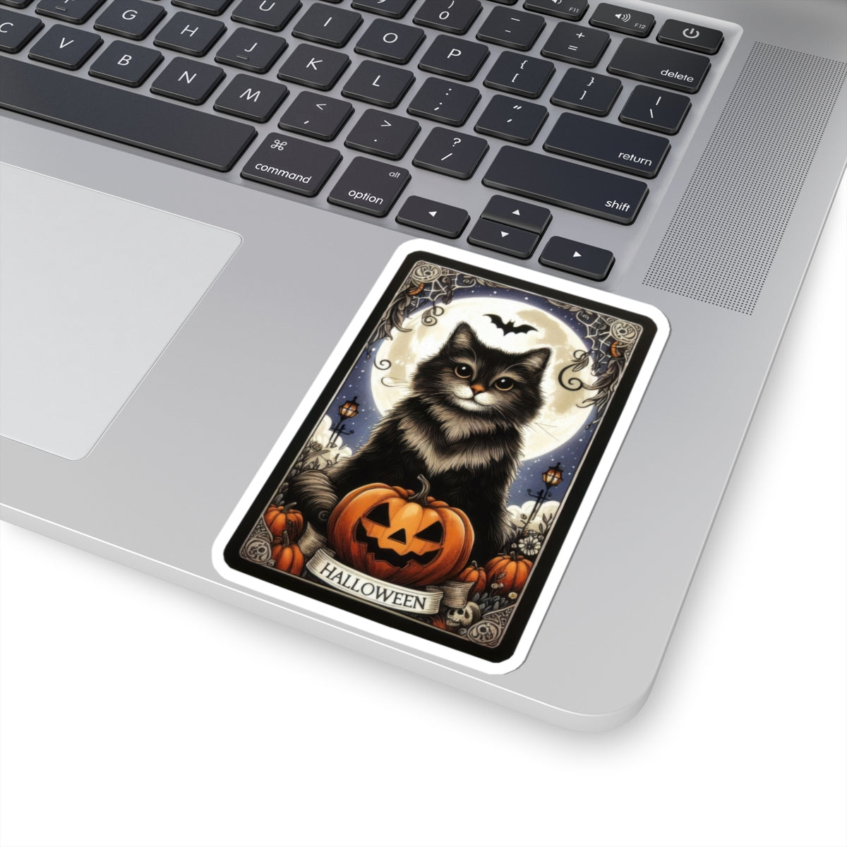 Halloween Cat Tarot Card Sticker with black cat, pumpkin, and spooky Halloween tarot design on laptop surface.