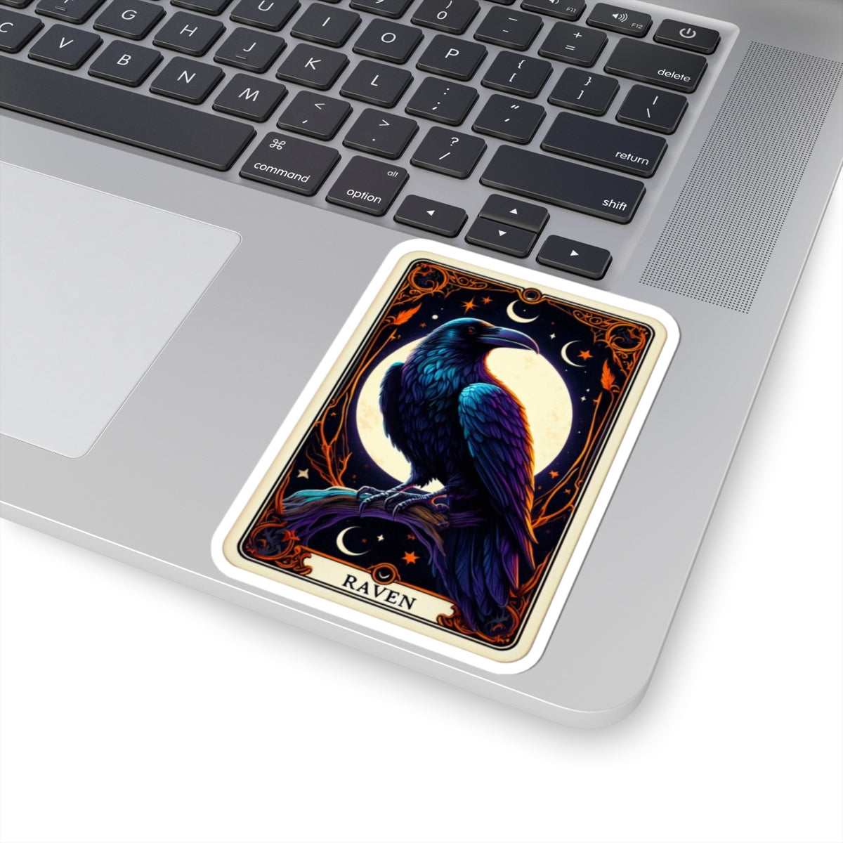 Decorative sticker of a raven on a laptop keyboard