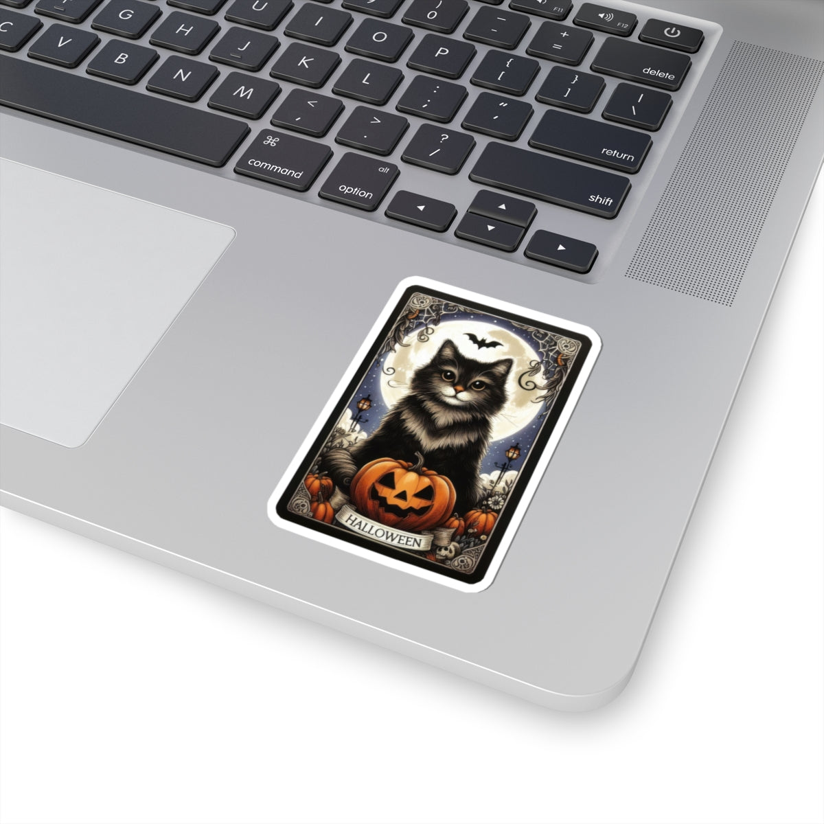 Halloween Cat Tarot Card Sticker featuring a black cat with Halloween pumpkin on a laptop surface.
