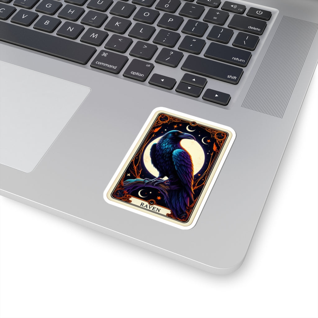 Sticker of a raven with moon and star design on a laptop