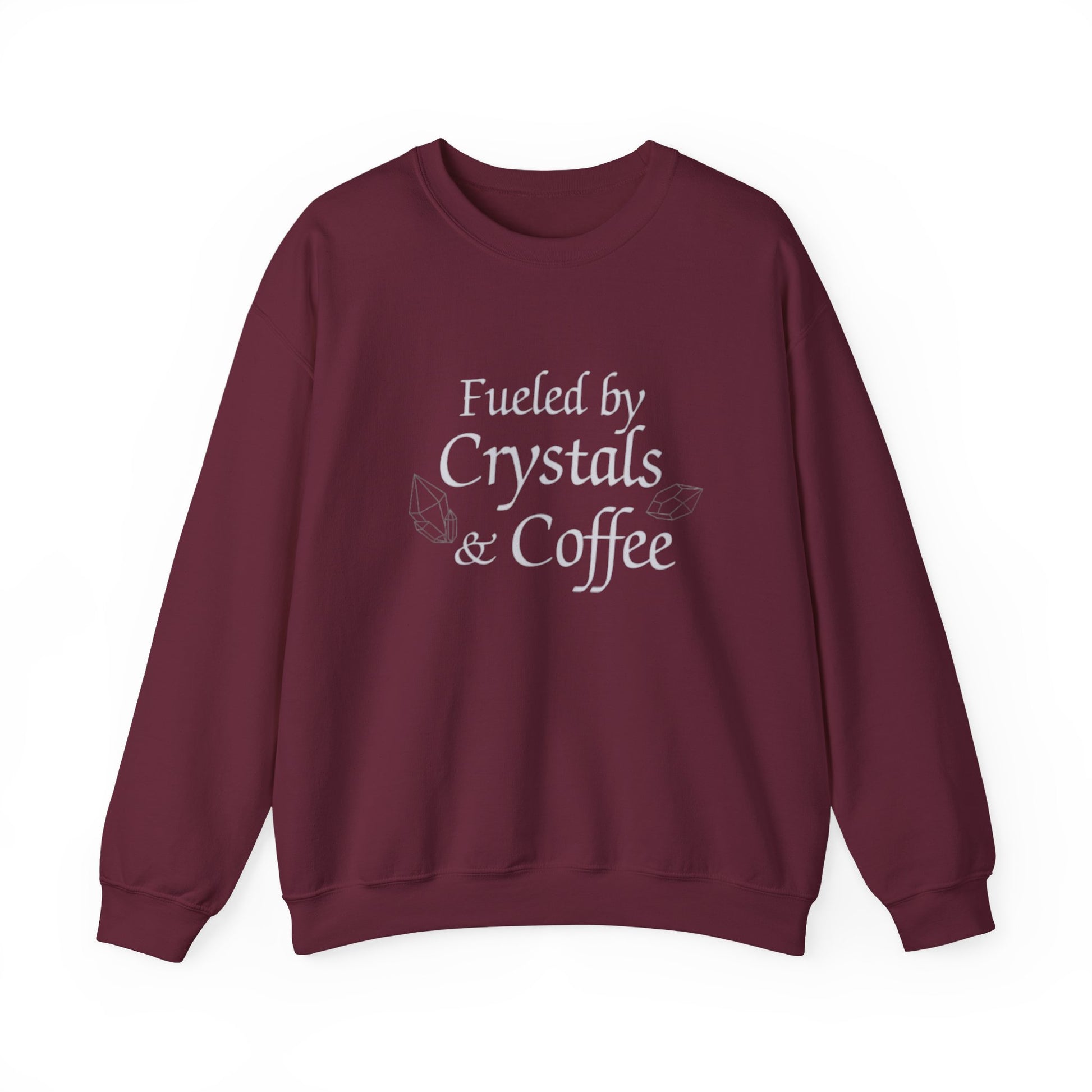 Maroon sweatshirt with 'Fueled by Crystals & Coffee' text on a white background