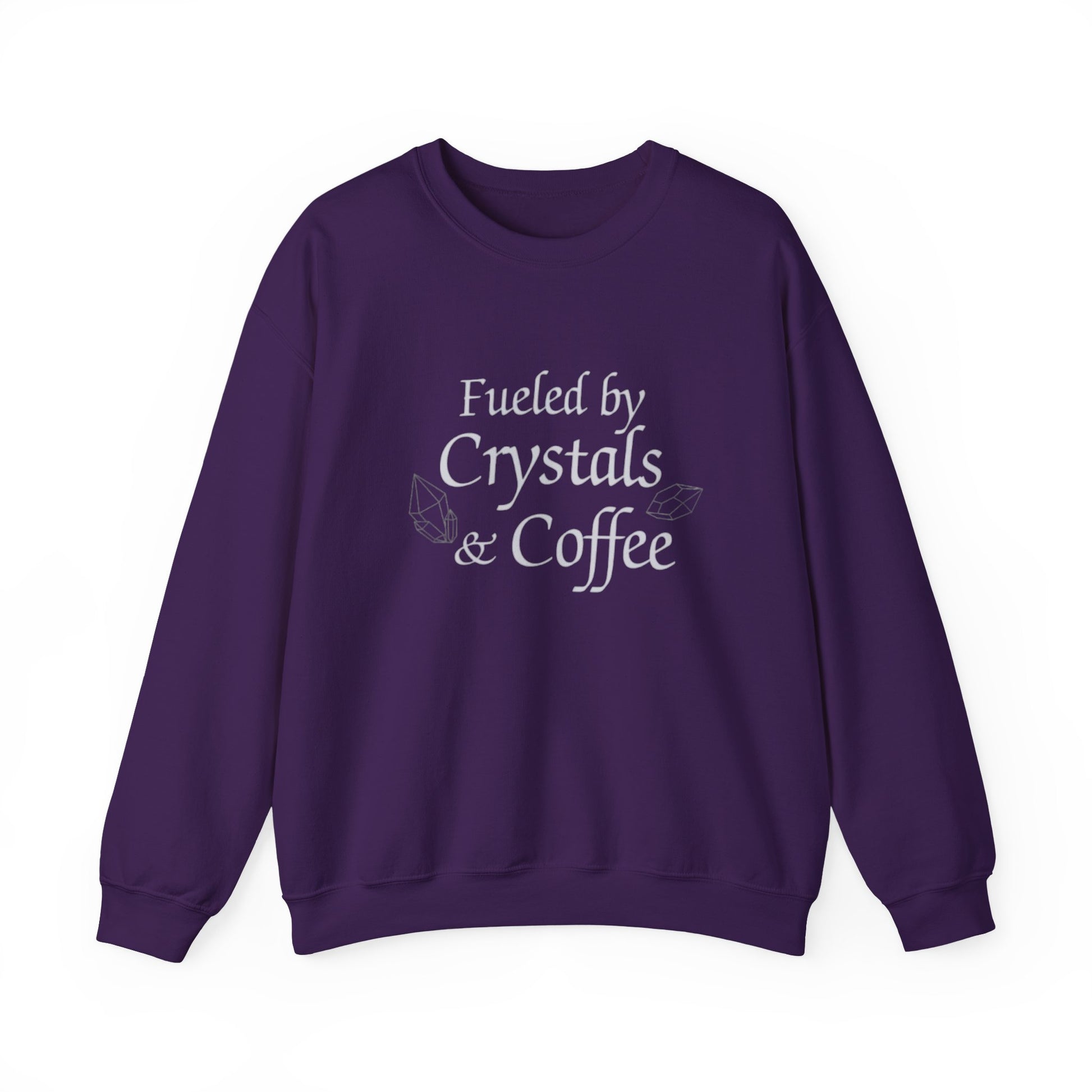 Purple sweatshirt with 'Fueled by Crystals & Coffee' text on a white background
