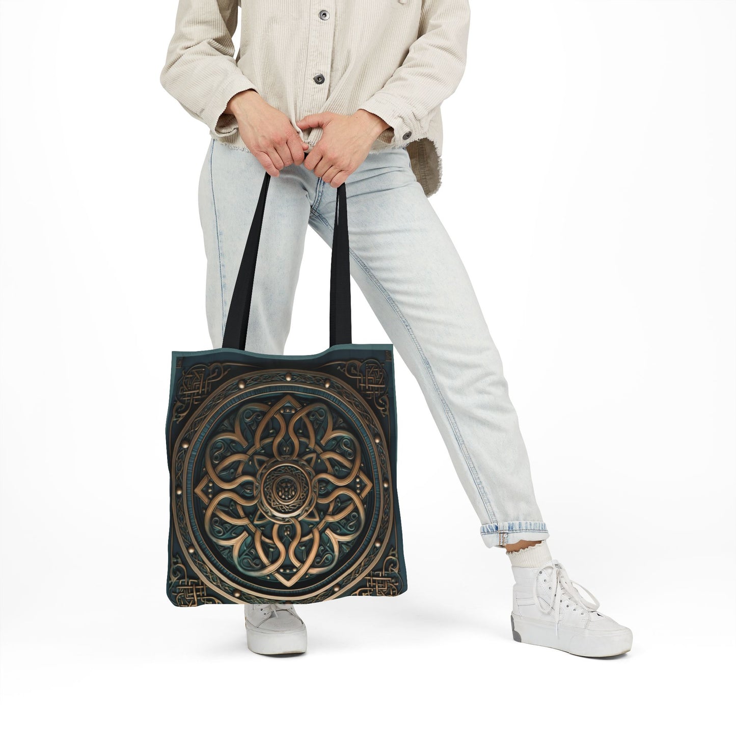 Celtic Shield Knot Turquoise and Bronze Tote Bag held by person wearing light jeans and beige jacket.