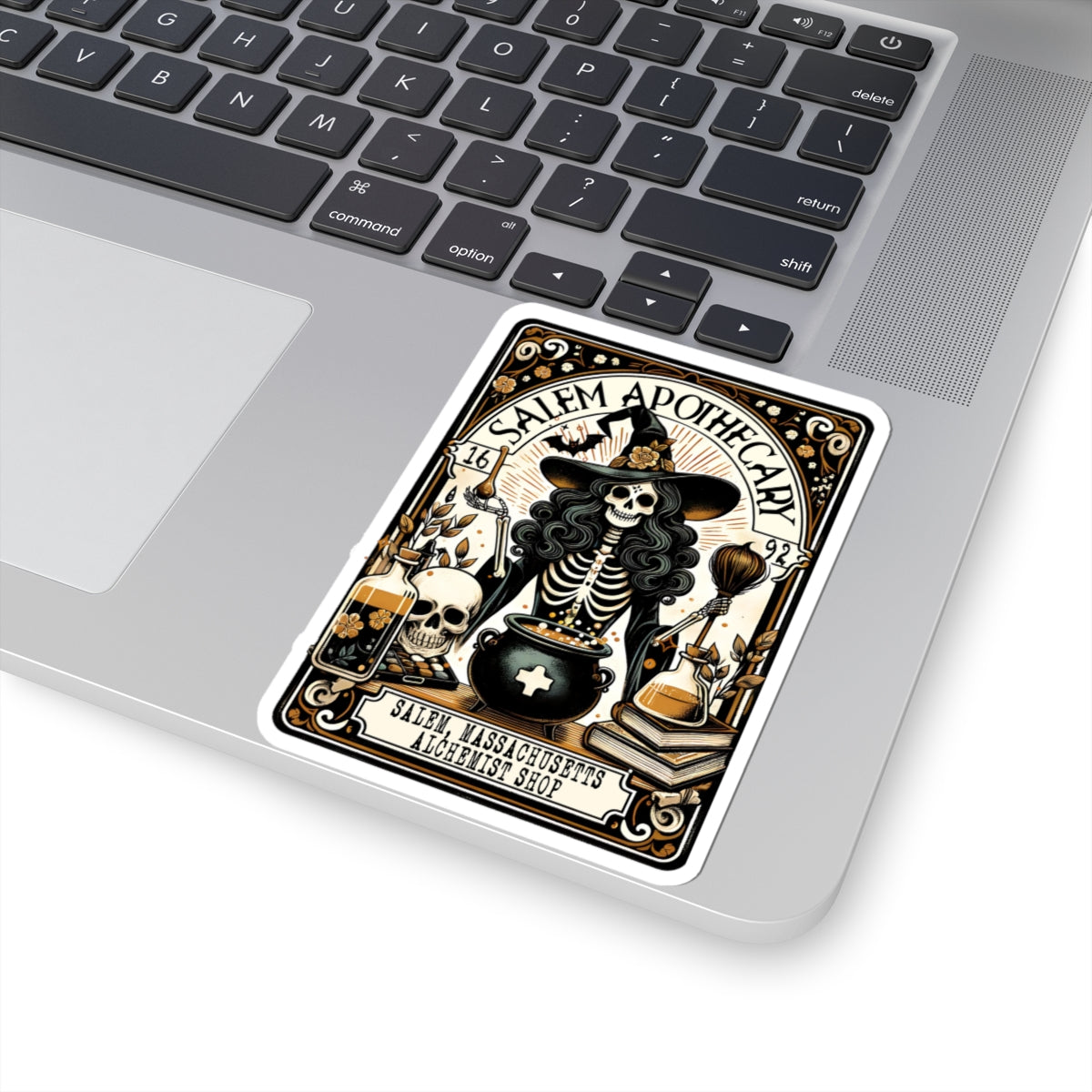 Salem Witchcraft themed card on a laptop keyboard