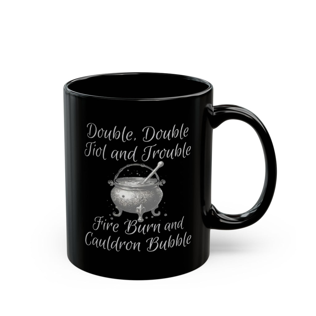 Black mug with white text and a cauldron design on a white background