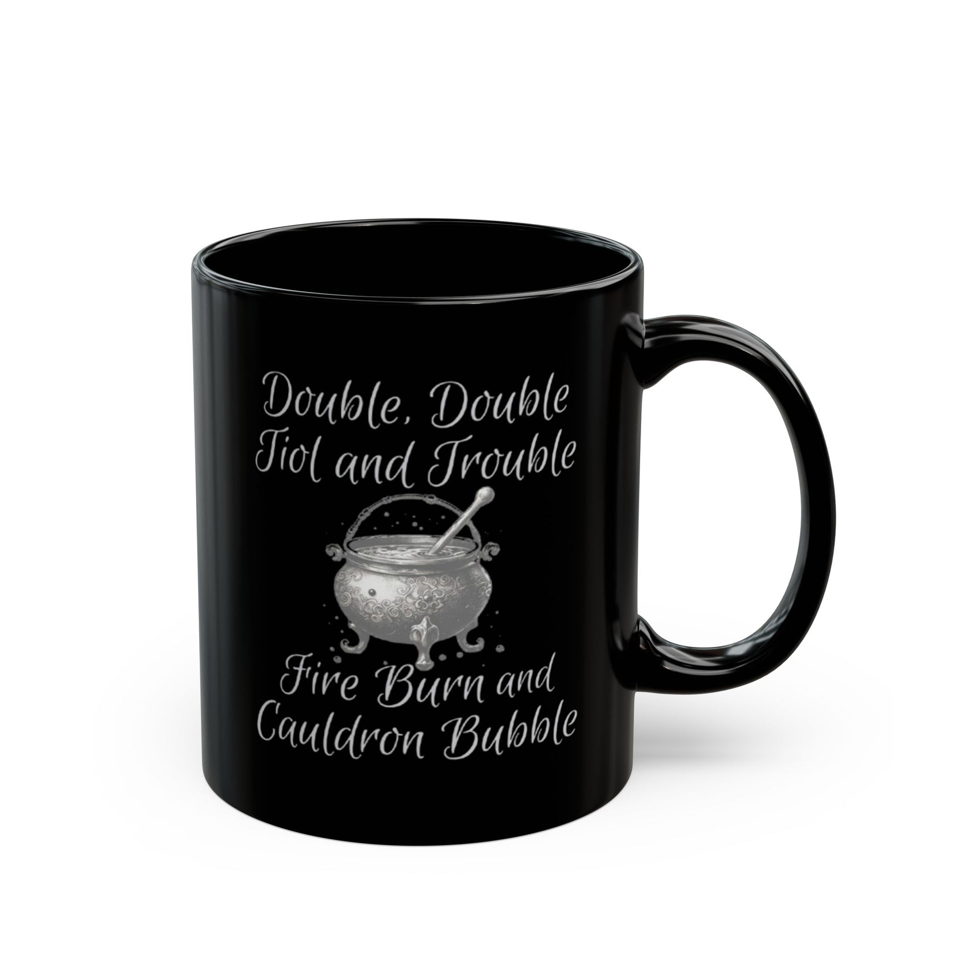 Black mug with white text and a cauldron design on a white background